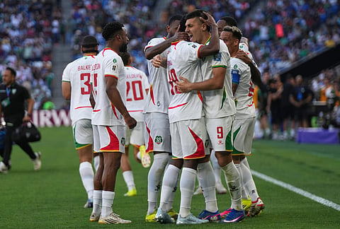 Suriname's players celebrate their side's opening goal scored by Liam van Genderen during a World Cup playoff semifinal soccer match between Bolivia and Suriname in Monterrey, Mexico.