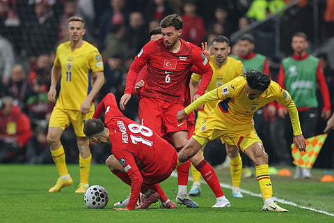 Romania's Ștefan Baiaram, right, vies for the ball with Turkey's Mert Muldur during the 2026 World Cup playoff semifinal soccer match between Turkey and Romania, in Istanbul, Turkey.