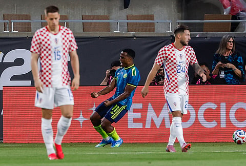 Colombia defender Yerson Mosquera, center, celebrates after scoring a goal as Croatia midfielder Lovro Majer (15) and forward Petar Musa (24) walk away during the first half of an international friendly soccer game in Orlando, Florida.
