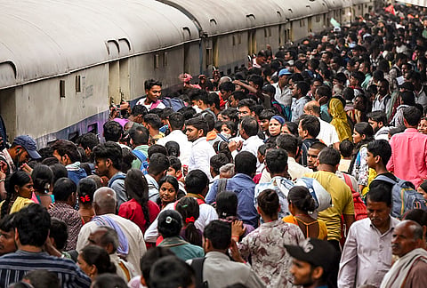 Passengers throng a railway station to board a train after the conclusion of 'Ram Navami' and ‘Chaiti Chhath’ festivals, in Patna.