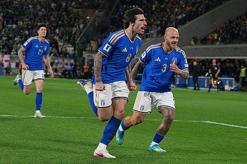 Italy's Federico Dimarco, right, celebrates with teammate Sandro Tonali who scored his side's first goal during the World Cup qualifying play-off soccer match between Italy and Northern Ireland, in Bergamo, Italy.