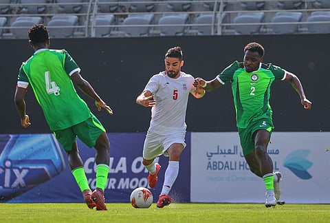 Iran's Milad Mohammadi, left, tussles for the ball with Nigeria's Bright Osayi-Samuel during a friendly soccer match between Iran and Nigeria in Antalya, southern Turkey.