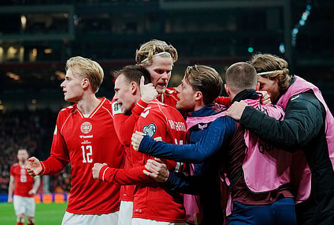 Denmark's Mikkel Damsgaard, second left, celebrates scoring a goal with teammates during the World Cup playoff semifinal soccer match between Denmark and North Macedonia in Copenhagen.
