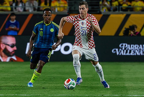 Croatia forward Ivan Perisic (21) brings the ball down the pitch against Colombia defender Yerson Mosquera (11) during the second half of an international friendly soccer game, in Orlando, Florida.