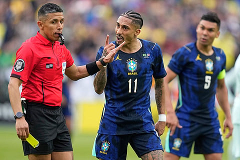 Brazil's Raphinha gestures at referee Guido Gonzales Jr. during the international friendly soccer match between Brazil and France in Foxborough, Mass.