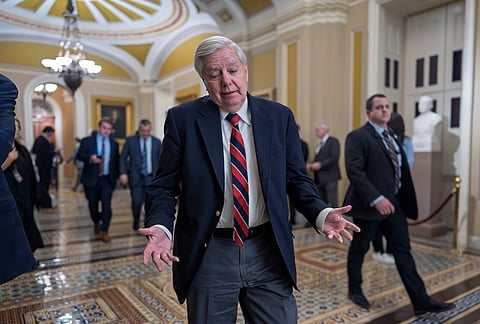 Sen. Lindsey Graham, R-S.C., walks to the chamber for votes after meeting behind closed doors with fellow Republicans on the Homeland Security budget stalemate, at the Capitol in Washington.
