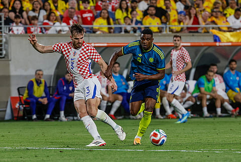 Croatia defender Marin Pongracic (3) and Colombia defender Deiver MacHado (9) go for the ball during the second half of an international friendly soccer game, in Orlando, Florida.