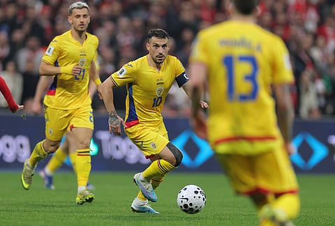 Romania's Nicolae Stanciu runs with the ball during the 2026 World Cup playoff semifinal soccer match between Turkey and Romania, in Istanbul.