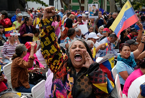 A woman screams during a government-organized event to watch former President Nicolas Maduro and first lady Cilia Flores appear in a New York court on a screen in Caracas, Venezuela.
