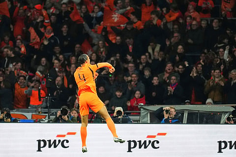 Netherlands' Virgil van Dijk celebrates after scoring his side's first goal during the international friendly soccer match between the Netherlands and Norway in Amsterdam, Netherlands.