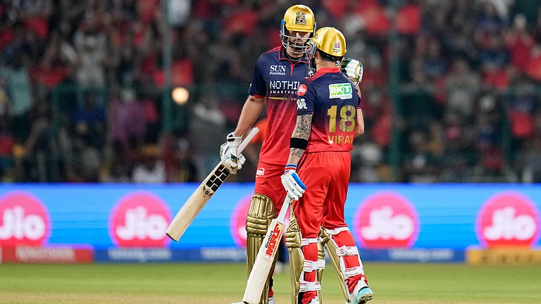 Royal Challengers Bengaluru's Virat Kohli, right, celebrates his fifty runs with batting partner Tim David during the Indian Premier League cricket match between Royal Challengers Bengaluru and Sunrisers Hyderabad in Bengaluru, India, Saturday, March 28, 2026 - (AP Photo/Aijaz Rahi)