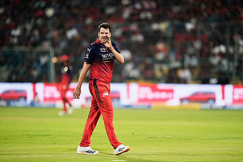 Royal Challengers Bengaluru's Jacob Duffy sets his field as he prepares to bowl a delivery during the Indian Premier League cricket match between Royal Challengers Bengaluru and Sunrisers Hyderabad in Bengaluru, India.