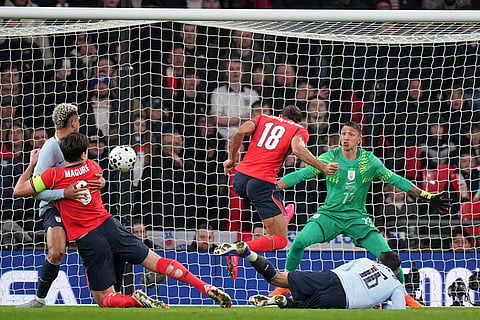 England's Dominic Calvert-Lewin, center, misses a chance during the international friendly soccer match between England and Uruguay in London.