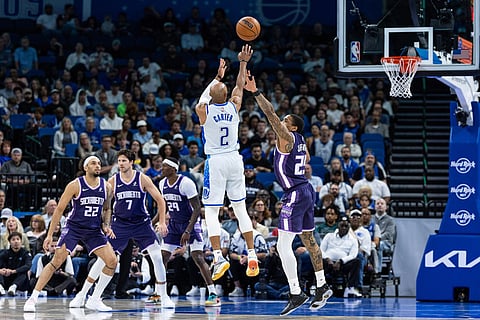 Orlando Magic guard Jevon Carter (2) shoots a 3-point basket during the first half of an NBA basketball game against the Sacramento Kings in Orlando, Fla.