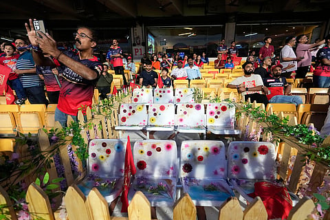 Flowers are placed on 11 seats kept at M Chinnaswamy Stadium as a tribute to eleven Royal Challengers Bengaluru fans who lost their lives in a stampede last year, as spectators wait for the Indian Premier League cricket match between Royal Challengers Bengaluru and Sunrisers Hyderabad to begin in Bengaluru, India.