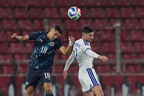 Paraguay's Alex Arce, left, challenges for the ball with Greece's Giorgos Masouras during the international friendly soccer match between Greece and Paraguay in Piraeus, Greece.