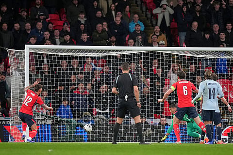 England's Ben White, left, scores his side's opening goal during the international friendly soccer match between England and Uruguay in London.