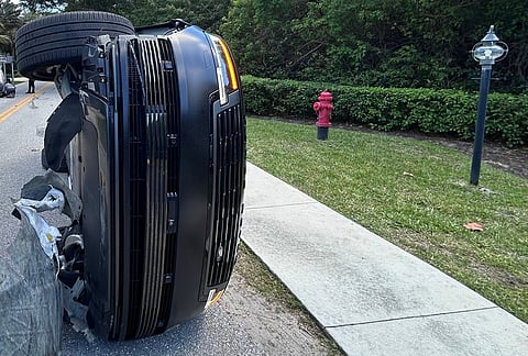 This photo provided by the Martin County Sheriff's Office shows the overturned vehicle in a rollover crash which involved Tiger Woods in Jupiter Island, Florida.