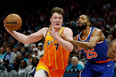 Charlotte Hornets guard Kon Knueppel (7) drives against New York Knicks guard Mikal Bridges during the second half of an NBA basketball game in Charlotte, N.C.