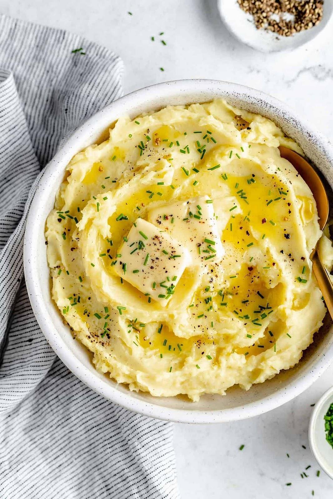 Mashed potatoes with melting butter and chives.