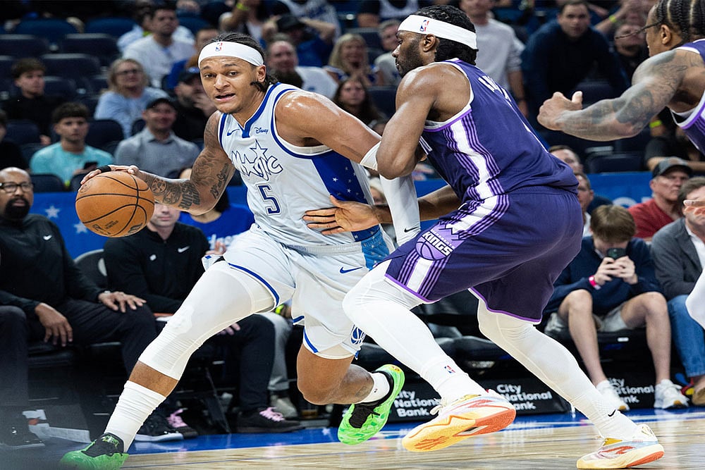 | Photo: AP/Willie J. Allen Jr. : Orlando Magic forward Paolo Banchero (5) dribbles by Sacramento Kings forward Precious Achiuwa (9) during the second half of an NBA basketball game in Orlando, Fla.