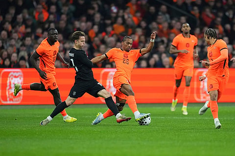 Netherlands' Quinten Timber, centre, and Brian Brobbey, left, challenge for the ball with Norway's Felix Horn Myhre, second from left, during the international friendly soccer match between the Netherlands and Norway in Amsterdam, Netherlands.