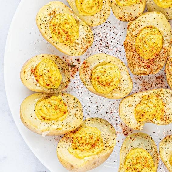 Deviled eggs on a white plate with paprika