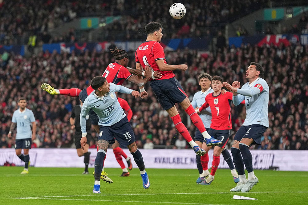 | Photo: AP/Alastair Grant : England's Dominic Solanke heads the ball during the international friendly soccer match between England and Uruguay in London.