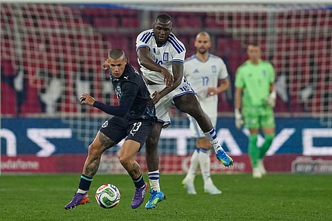 Paraguay's Alan Benitez, left, challenges for the ball with Greece's Andreas Tetteh during the international friendly soccer match between Greece and Paraguay in Piraeus, Greece.