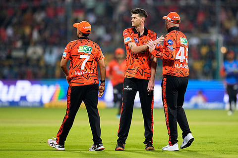 Sunrisers Hyderabad's David Payne, center, celebrates with teammates the wicket of Royal Challengers Bengaluru's captain Rajat Patidar during the Indian Premier League cricket match between Royal Challengers Bengaluru and Sunrisers Hyderabad in Bengaluru, India.