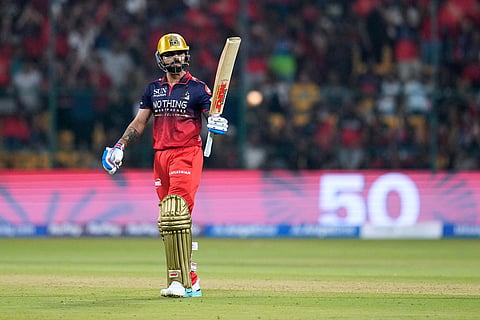 Royal Challengers Bengaluru's Virat Kohli celebrates his fifty runs during the Indian Premier League cricket match between Royal Challengers Bengaluru and Sunrisers Hyderabad in Bengaluru, India.