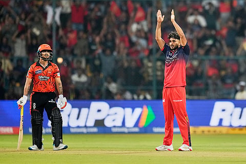 Royal Challengers Bengaluru's Abhinandan Singh celebrates the wicket of Sunrisers Hyderabad's captain Ishan Kishan, left, during the Indian Premier League cricket match between Royal Challengers Bengaluru and Sunrisers Hyderabad in Bengaluru, India.