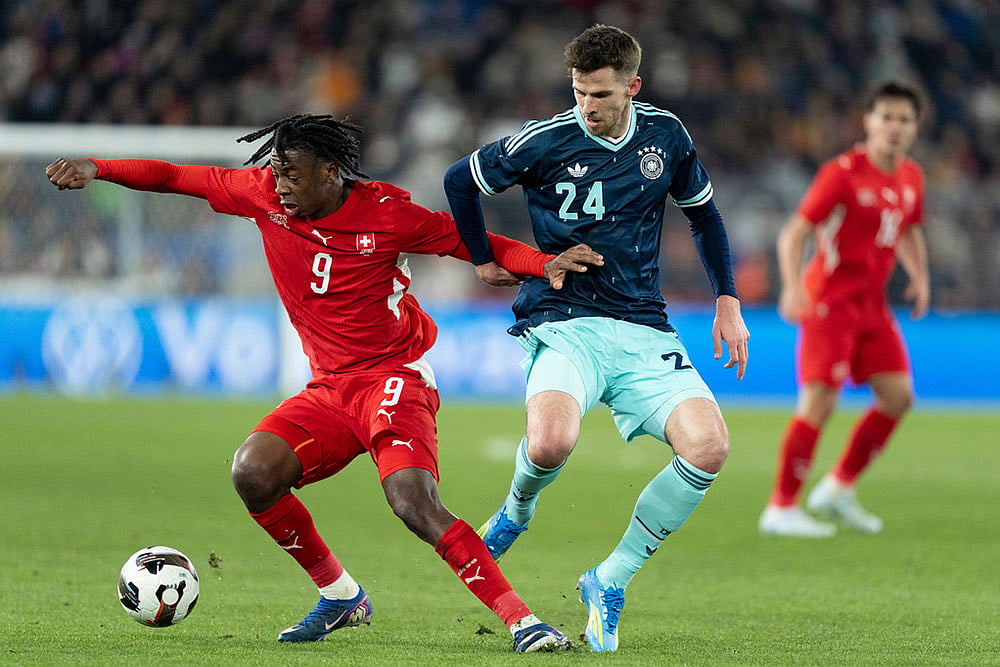 | Photo: Claudio Thoma/Keystone via AP : Switzerland's Johan Manzambi, left, shields the ball from Germany's Anton Stach, during an international friendly soccer match between Switzerland and Germany in Basel, Switzerland.