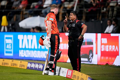Sunrisers Hyderabad's Heinrich Klaasen, left, unhappy with the third umpire's decision for his wicket, has a word with the fourth umpire during the Indian Premier League cricket match between Royal Challengers Bengaluru and Sunrisers Hyderabad in Bengaluru, India.
