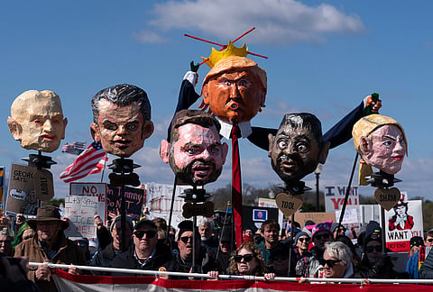 Demonstrators hold up their banners as they march across the Memorial Bridge during a "No Kings" protest in Washington.