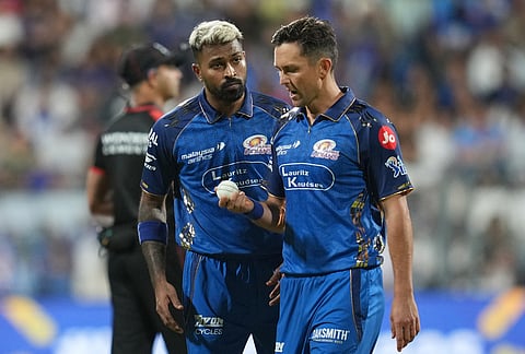 Mumbai Indians' captain Hardik Pandya, left, talks with Trent Boult during the Indian Premier League cricket match between Mumbai Indians and Kolkata Knight Riders in Mumbai.