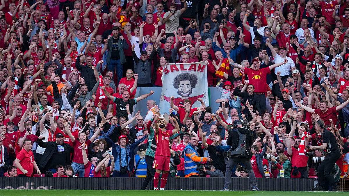 | Photo: AP/Jon Super : Liverpool's Mohamed Salah takes a selfie with a fans smartphone as he celebrates after scoring his side's fourth goal during the English Premier League soccer match between Liverpool and Tottenham Hotspur at Anfield in Liverpool, England, Sunday, April 27, 2025. 