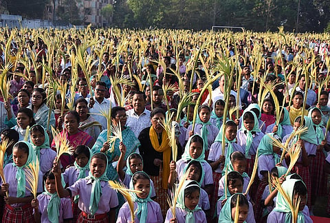 Christians hold palm branches as they offer prayers on the occassion of Palm Sunday at Roman Catholic Church, in Ranchi, Jharkhand.