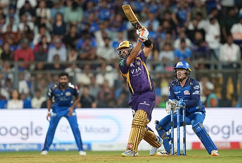 Kolkata Knight Riders' captain Ajinkya Rahane, center, plays a shot during the Indian Premier League cricket match between Mumbai Indians and Kolkata Knight Riders in Mumbai.