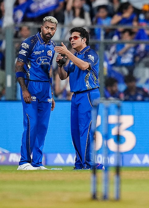 Mumbai Indians' captain Hardik Pandya, left, with cricket legend and the team's icon Sachin Tendulkar before an Indian Premier League (IPL) 2026 T20 cricket match between Mumbai Indians and Kolkata Knight Riders, at the Wankhede Stadium, in Mumbai, Maharashtra.