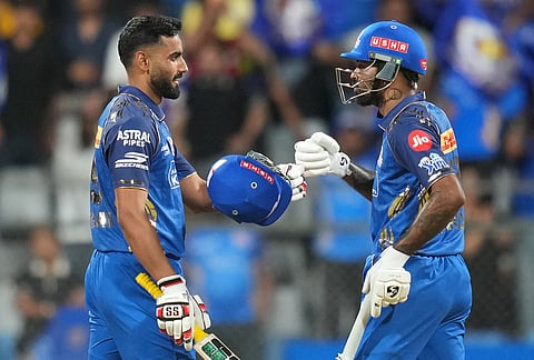 Mumbai Indians' captain Hardik Pandya, right, and Naman Dhir celebrate after won the match during the Indian Premier League cricket match between Mumbai Indians and Kolkata Knight Riders in Mumbai.