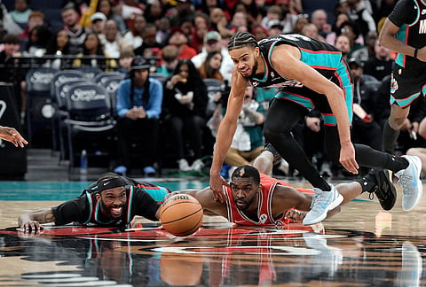 Memphis Grizzlies guard DeJon Jarreau, from left, Chicago Bulls forward Patrick Williams, and guard Rayan Rupert chase a loose ball in the second half of an NBA basketball game in Memphis, Tennessee.