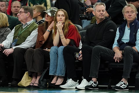 Model Mallory Edens looks on during the first half of an NBA basketball game between the Milwaukee Bucks and the San Antonio Spurs, in Milwaukee. 
