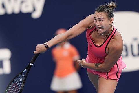 Aryna Sabalenka serves to Coco Gauff during the women's singles final at the Miami Open tennis tournament, in Miami Gardens, Florida.