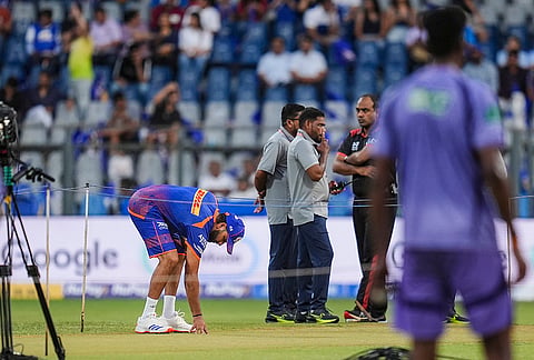 Mumbai Indians' Rohit Sharma inspects the pitch before an Indian Premier League (IPL) 2026 T20 cricket match between Mumbai Indians and Kolkata Knight Riders, at the Wankhede Stadium, in Mumbai, Maharashtra.