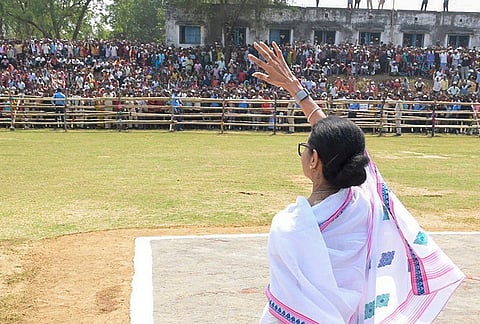 West Bengal Chief Minister Mamata Banerjee waves to the gathering during a public rally, in Raipur village, Bankura district, West Bengal. 