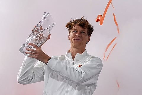 Jannik Sinner of Italy hoists the Butch Buchholz trophy after defeating Jiri Lehecka of the Czech Republic in the men's singles final at the Miami Open tennis tournament, in Miami Gardens, Florida.