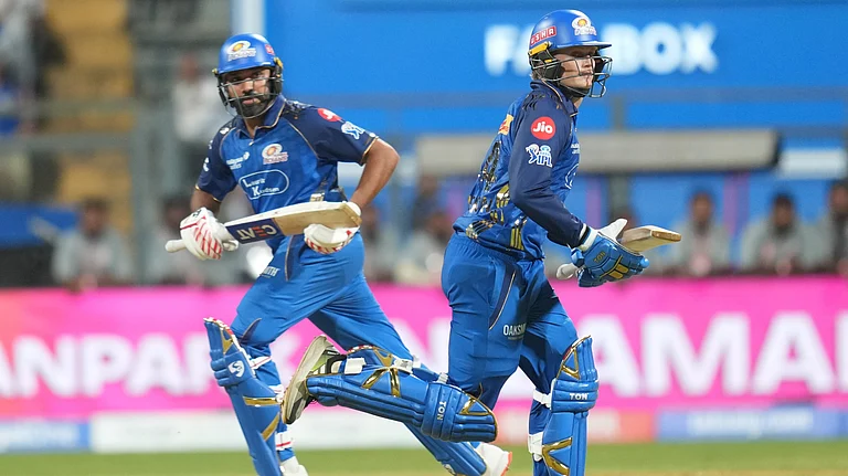 Mumbai Indians' Rohit Sharma, left, and Ryan Rickelton run between the wickets during the Indian Premier League cricket match between Mumbai Indians and Kolkata Knight Riders in Mumbai, India, Sunday, March 29, 2026. - | Photo: AP/Rafiq Maqbool