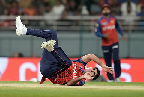 Punjab Kings' Xavier Bartlett loses balance after bowling a delivery during the Indian Premier League cricket match between Gujarat Titans and Punjab Kings in New Chandigarh.