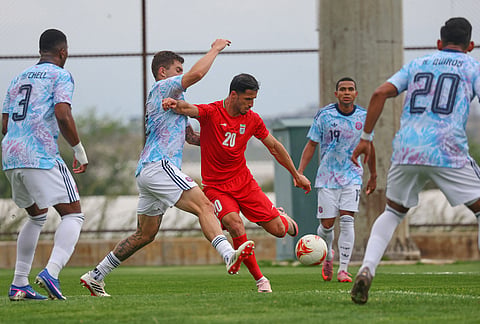 Iran's Ali Alipour, center, vies for the ball with Costa Rica's defenders during a friendly soccer match between Iran and Costa Rica, in Antalya, southern Turkey.
